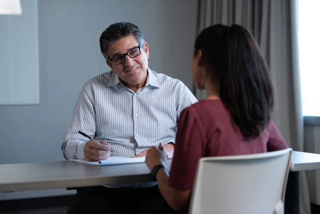 A member gives one-on-one feedback to another member after a speech