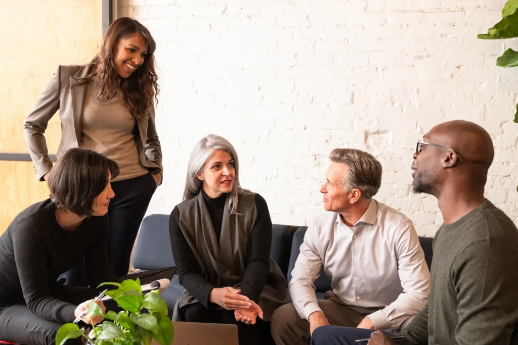 A small group of members chat and laugh together
